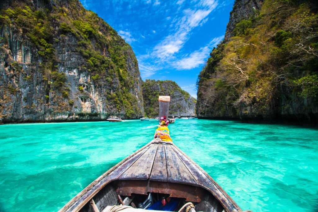 Traditional wooden  boat in a picture perfect tropical bay on Koh Phi Phi Island, Thailand, Asia.