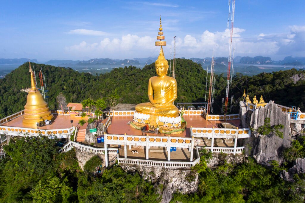 Tiger Cave or Wat Thum Sua temple is a major tourist destination.  At the top of the mountain there is a large golden Buddha statue which is a popular tourist attraction.